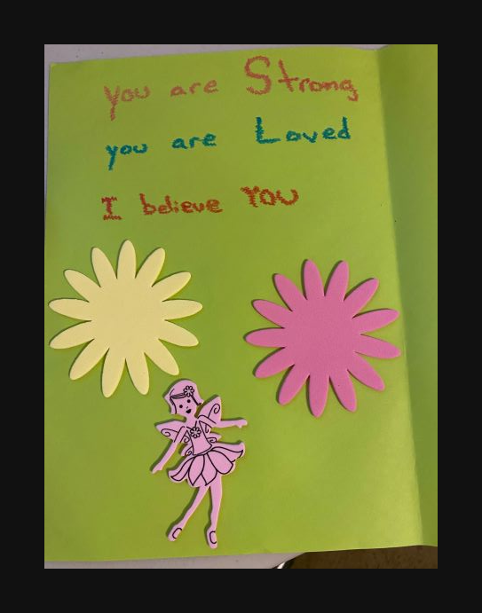 Handwritten letter with "you are strong. You are loved. I believe you." Two foam flowers and a foam fairy line the bottom.